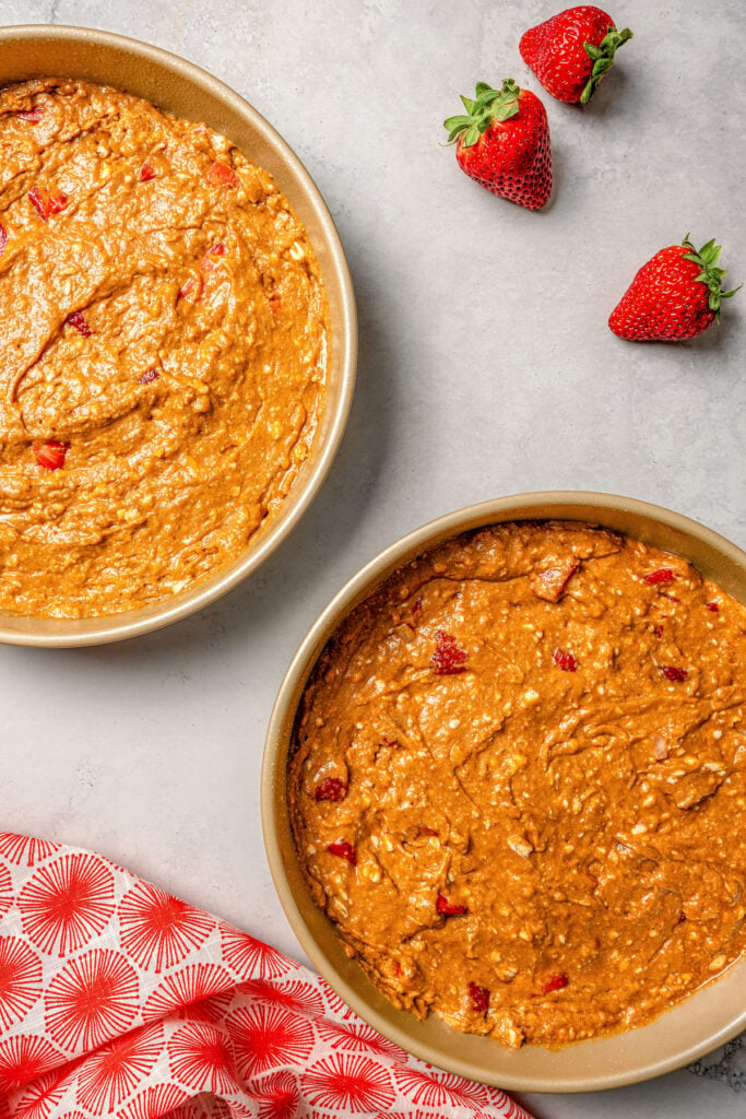 Pouring batter into the two cake pans. 