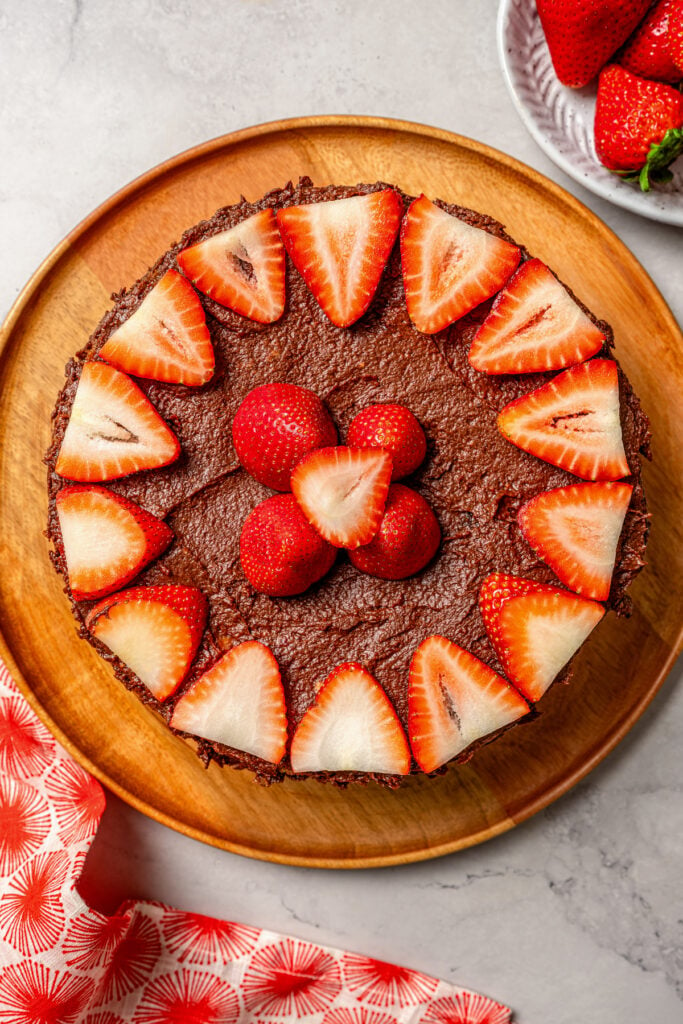 Chocolate-frosted cake decorated with sliced strawberries. 